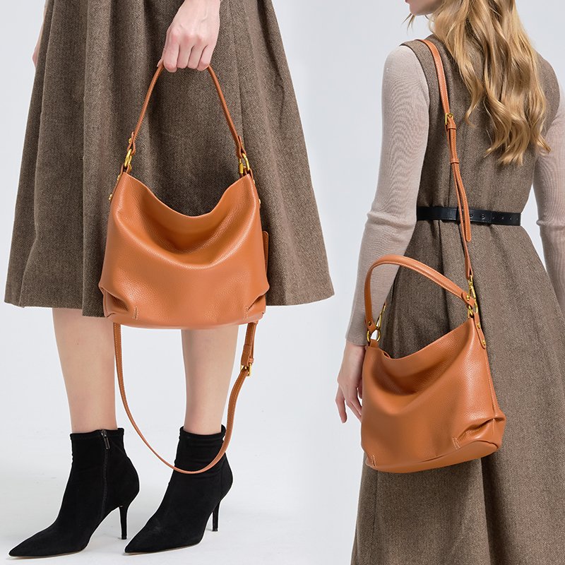 woman in studio carrying a donna puo leather bag model - Marcella in orange color